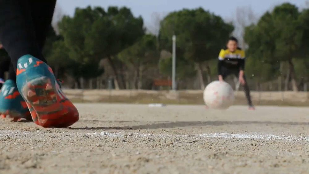 What is kickingball and why is it played in Spain?